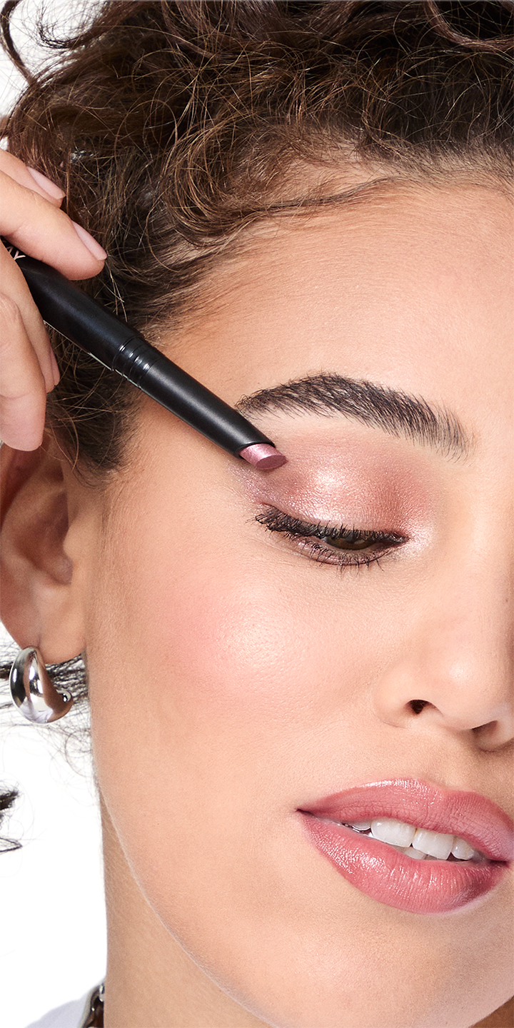 Model applying Mary Kay Shimmer Eye Shadow Stick to her eyelid